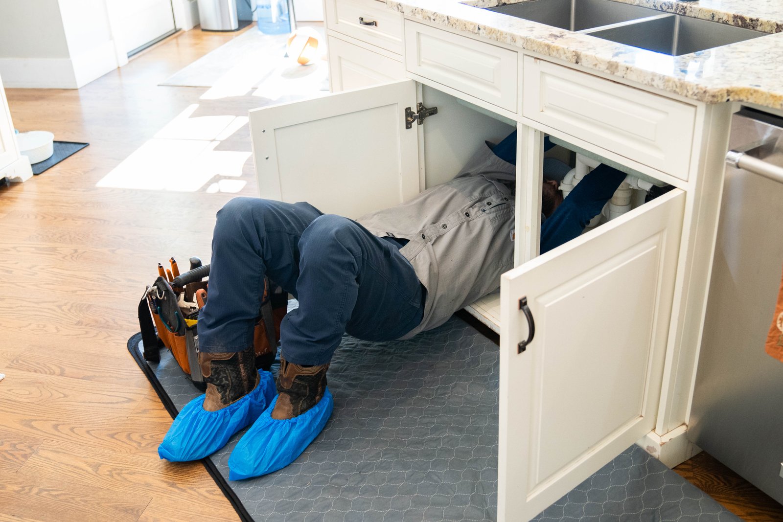 MasterFlo plumber clearing a clogged kitchen sink drain line in Cherokee County, GA
